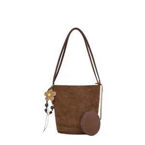 Brown suede bucket bag for women, retro commuting shoulder handbag with chic coin purse.