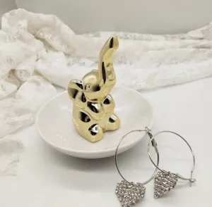 Détail de plat à bijoux éléphant en céramique nordique avec support de bague et boucles d'oreilles.