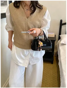 Korean style chic knit vest white shirt outfit with black pillow handbag for women.