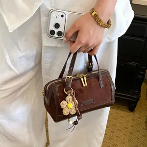 Stylish brown suede pillow handbag with floral charm, vintage top handle boston bag for women.