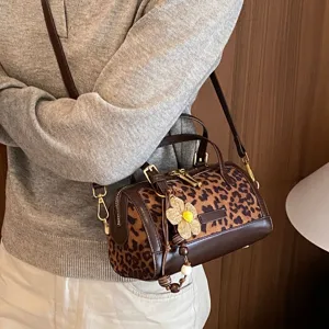 Korean style retro leopard print shoulder bag, chic barrel handbag with woven flower charm for women.