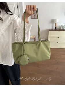 Minimalist green nylon underarm shoulder bag with small coin purse, casual daily handbag.