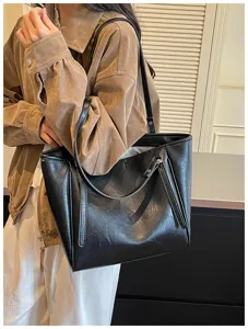 Detail van zwarte leren shopper tas, grote schoudertas, stijlvolle casual forensentas.