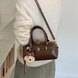 Vintage braune Boston Umhängetasche für Damen, stilvolle Handtasche mit Bärenanhänger.