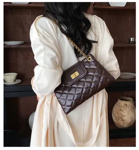 Chic dark brown quilted shoulder bag with gold chain strap and turn lock detail for women.