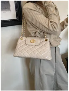 Beige quilted chain shoulder bag detail, elegant commuter handbag with classic design.