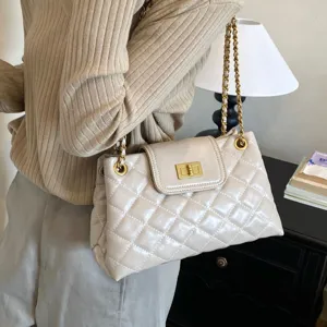 Quilted chain shoulder bag for women, elegant commuter underarm handbag with chic hardware.