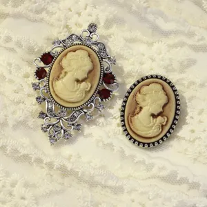 Vintage cameo brooch set featuring detailed lady profile portrait in ornate silver frame.