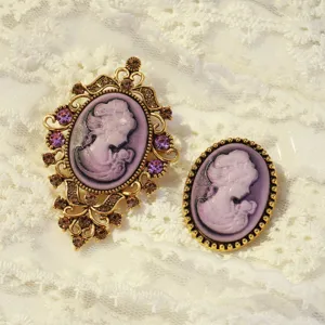 Vintage cameo brooch set featuring elegant purple portrait design with gold tone filigree.