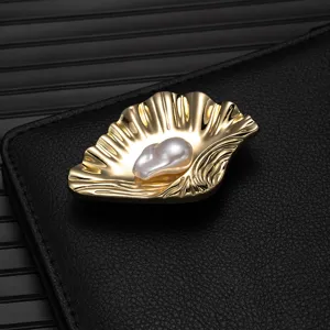 Exquisite gold shell pearl brooch, elegant alloy lapel pin accessory for suits and dresses.