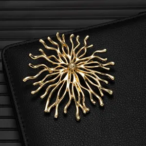 Close-up of exquisite gold alloy abstract branch brooch detail, showcasing fine metallic texture.