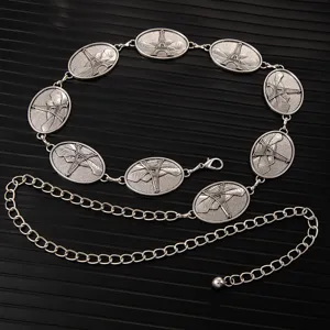 Close up of silver metal waist chain with retro Eiffel Tower relief medallions for dresses.