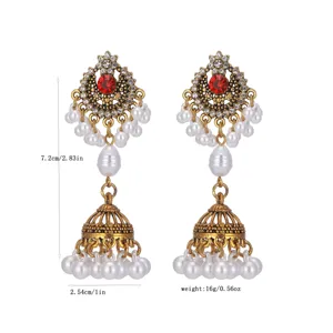 Vintage ethnic Jhumka earrings with white pearls and red rhinestone, elegant style drop design.
