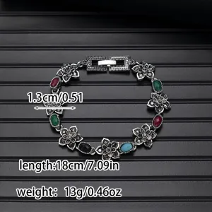 Vintage retro style flower bracelet with colorful stones, delicate ethnic jewelry detail view.