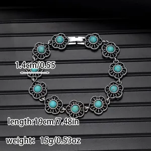 Detailed view of vintage turquoise flower bracelet, ethnic style alloy metal jewelry piece.