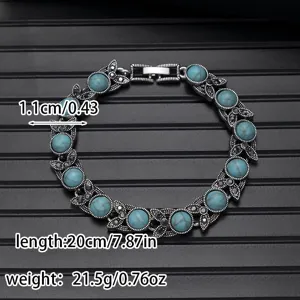 Detail shot of vintage turquoise bracelet showing exquisite metal carving and stone texture.