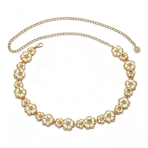 Close-up detail of the metal flower chain belt, showing exquisite floral links and fine texture.