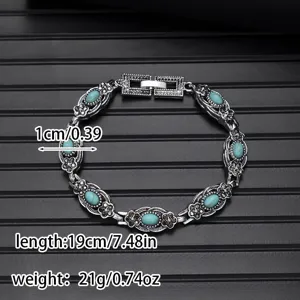 Retro vintage turquoise gemstone bracelet with floral silver link chain detail for women.