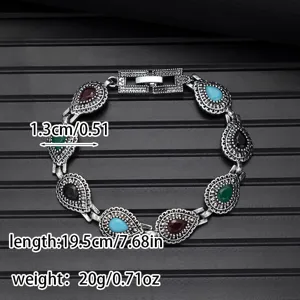 Vintage multi-color stone bracelet close-up detail, silver-tone metal intricate carved link chain.