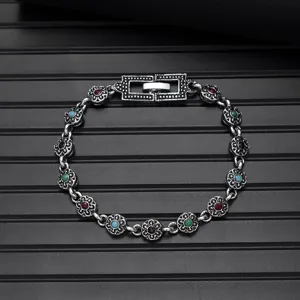Vintage alloy metal chain bracelet with colorful mosaic stones and floral links detail view.