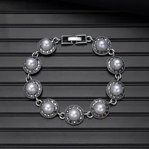 Vintage silver pearl bracelet detail shot, elegant round design with intricate metal craftsmanship.