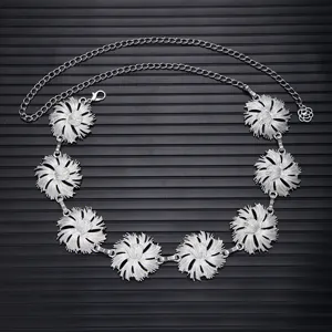 Silver metal waist chain with elegant floral charms, perfect dress accessory for women.