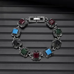 Vintage multi-color gemstone bracelet close-up, retro silver-tone square link design.