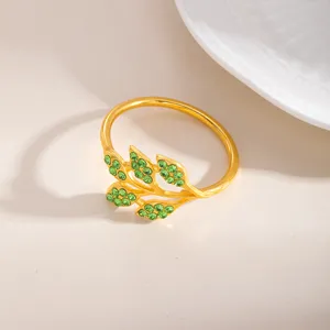 Portatovaglioli in lega dorata con design a foglia di strass verdi per decorare la tavola.
