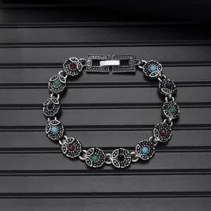 Vintage ethnic style turquoise metal bracelet detail with exquisite floral links.