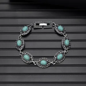 Detailed view of vintage silver turquoise bracelet with intricate carved links and secure clasp.