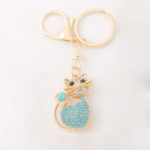 Detail view of the elegant rhinestone cat keychain featuring sparkling blue and clear crystals.