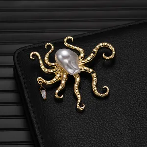 Detailed view of gold octopus brooch showcasing baroque pearl head and crystal pendant.