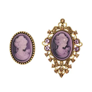Vintage cameo brooch set with ornate gold frame and purple profile, elegant retro jewelry.