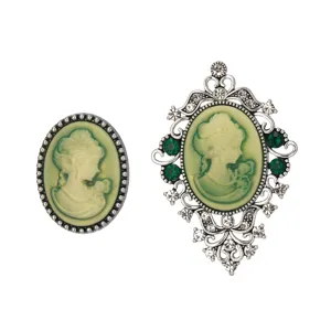 Vintage cameo brooch set with green resin portrait and sparkling rhinestone details.