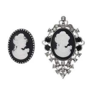 Detailed close-up of vintage cameo brooch set featuring classic profile portrait and rhinestones.