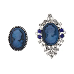 Vintage blue cameo brooch detail showing exquisite filigree metalwork and sparkling rhinestones.