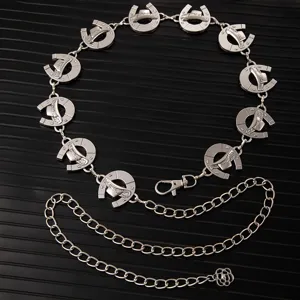 Vintage silver tone metal waist chain with horseshoe and hat charms for dress party wear.