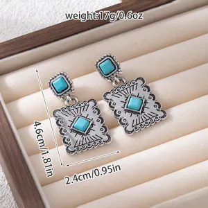 Detailed shot of vintage bohemian turquoise drop earrings with exquisite engraved metal texture.