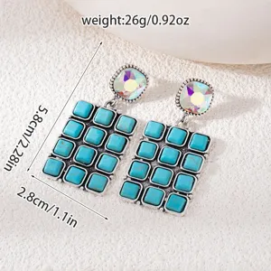 Close-up detail of vintage bohemian turquoise crystal drop earrings with geometric stone design.