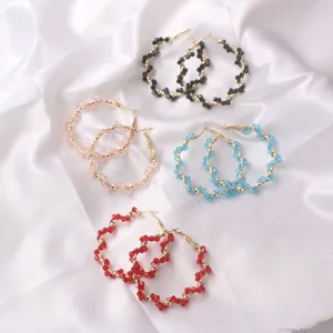 Colorful crystal beaded hoop earrings detail view, fashionable twisted metal circle earrings.