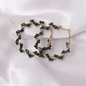 Detailed close-up of fashion European style wrapped crystal hoop earrings with black beads for women.