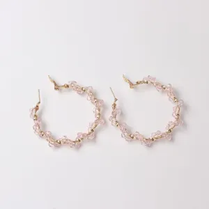 Chic pink crystal twisted hoop earrings for women, elegant fashion gold-plated jewelry.