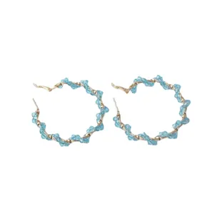 Fashionable blue crystal twisted hoop earrings for women, chic and elegant jewelry.