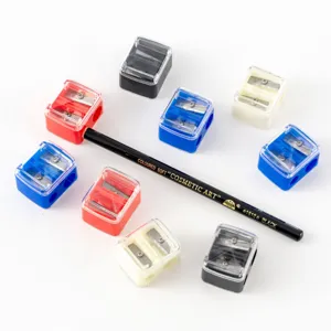Close-up detail of colorful dual-hole cosmetic pencil sharpeners and black eyeliner pencil.