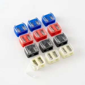 Dual-hole transparent plastic pencil sharpeners in assorted colors for makeup use.