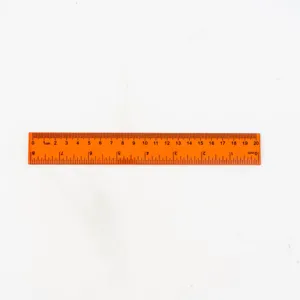 Orange transparent plastic ruler detail, 20cm length with clear metric and inch scale.