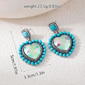 Close-up detail of vintage heart turquoise earrings with iridescent crystal and bead border.