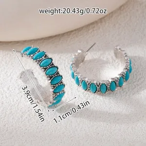 Detailed view of bohemian vintage turquoise hoop earrings featuring intricate silver metalwork.