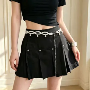 Close up detail of sweet cool Y2K multi layer pearl waist chain with stylish metal tassel accent.