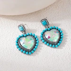 Bohemian vintage turquoise heart crystal earrings detail close-up, ethnic style retro jewelry.
